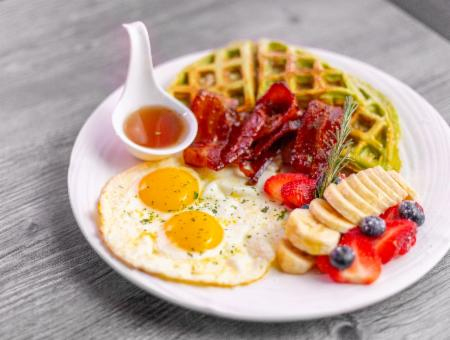 bacon, eggs, fruit and waffle