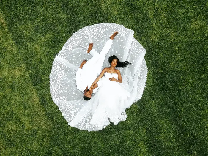 Wedding couple laying down in the grass