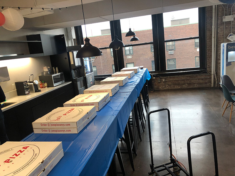 corporate catering lunch with pizzas on a table